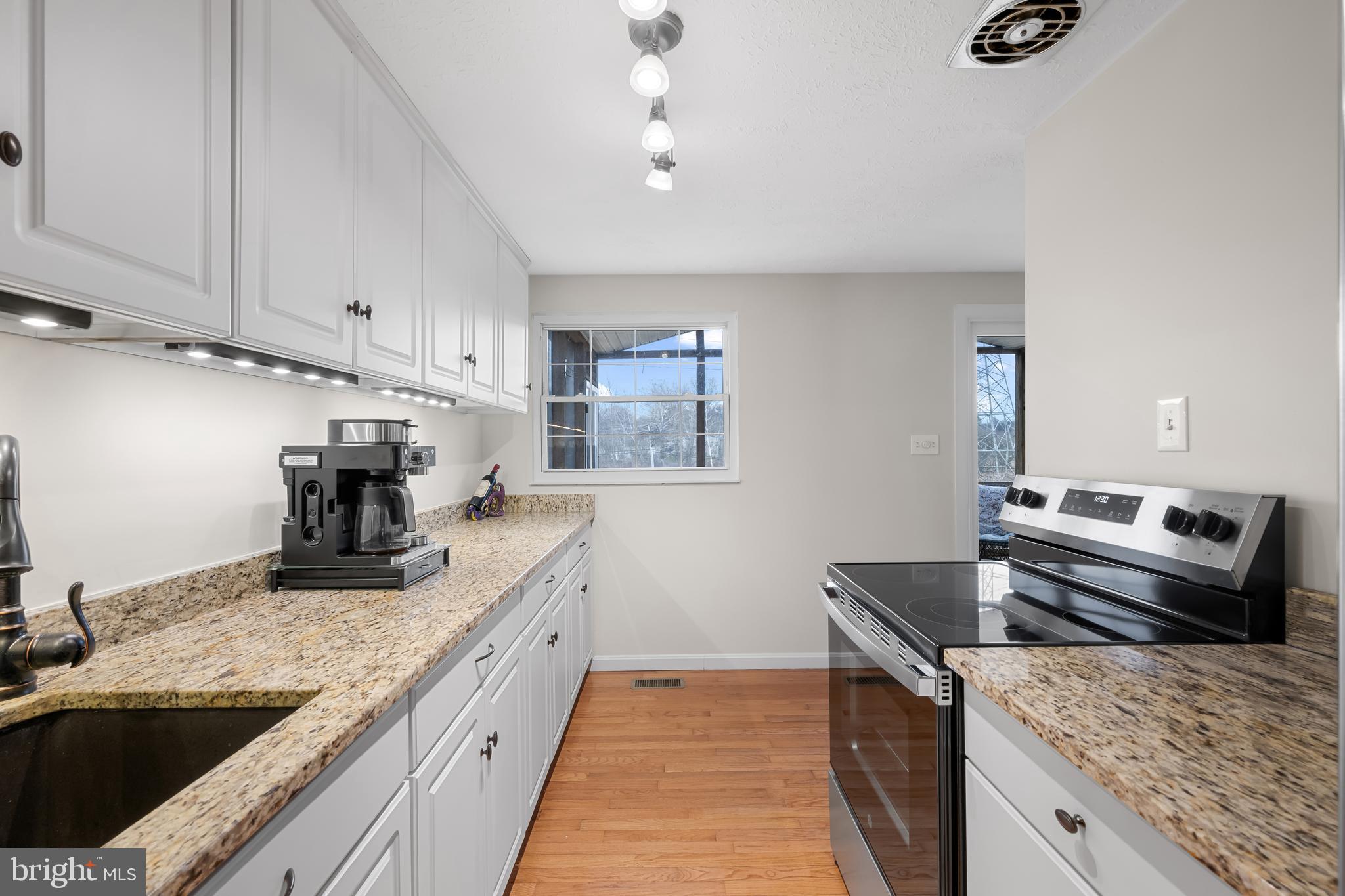 9281 Pigeon Wing Place Columbia, MD 21045 - Photo 17 of 55 a kitchen with a stove and a sink