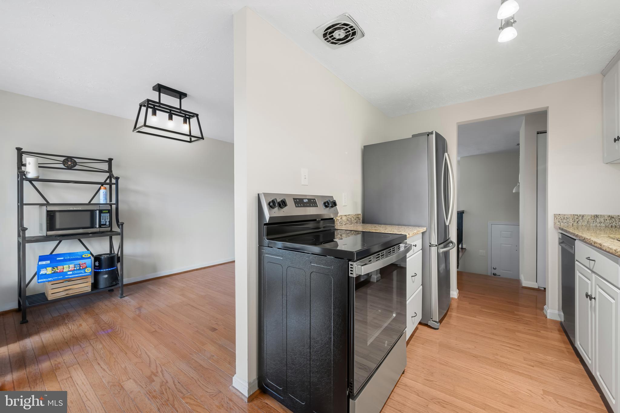 9281 Pigeon Wing Place Columbia, MD 21045 - Photo 20 of 55 a kitchen with a refrigerator and a stove