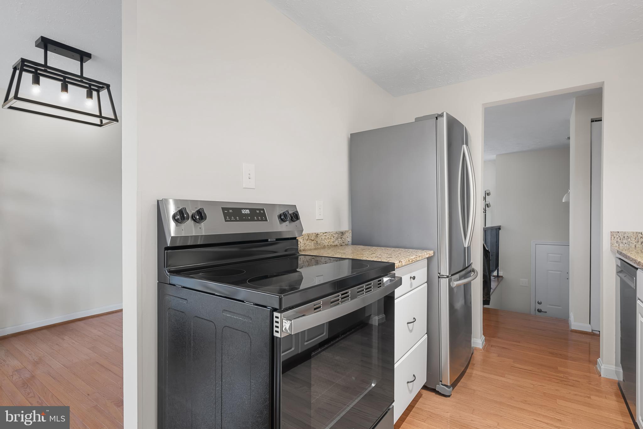 9281 Pigeon Wing Place Columbia, MD 21045 - Photo 21 of 55 a kitchen with a stove and a refrigerator