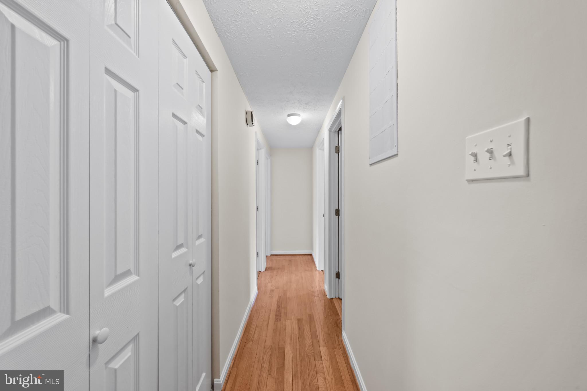 9281 Pigeon Wing Place Columbia, MD 21045 - Photo 22 of 55 a view of a hallway with wooden floor