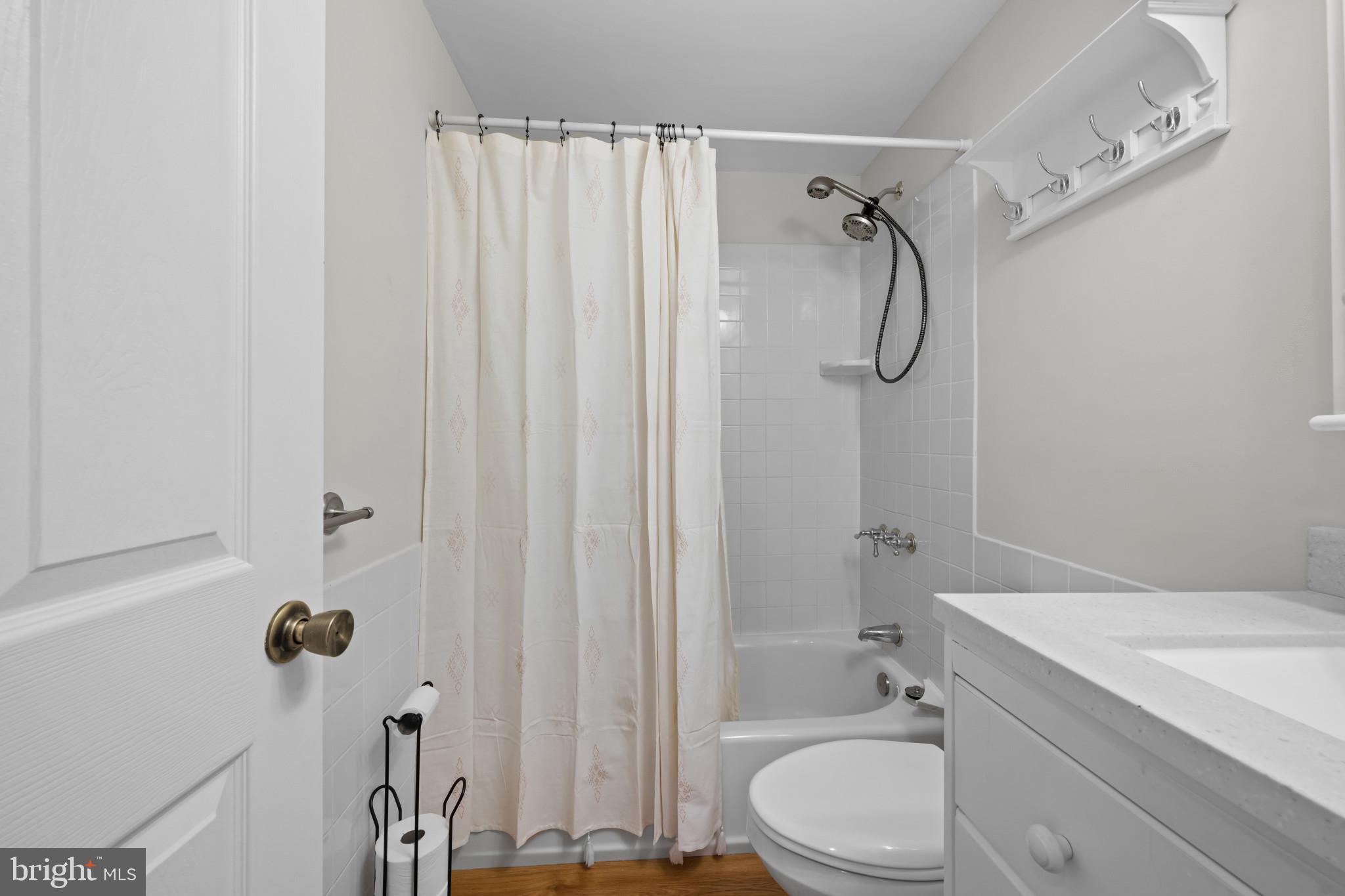 9281 Pigeon Wing Place Columbia, MD 21045 - Photo 24 of 55 a bathroom with a shower curtain a sink and a toilet