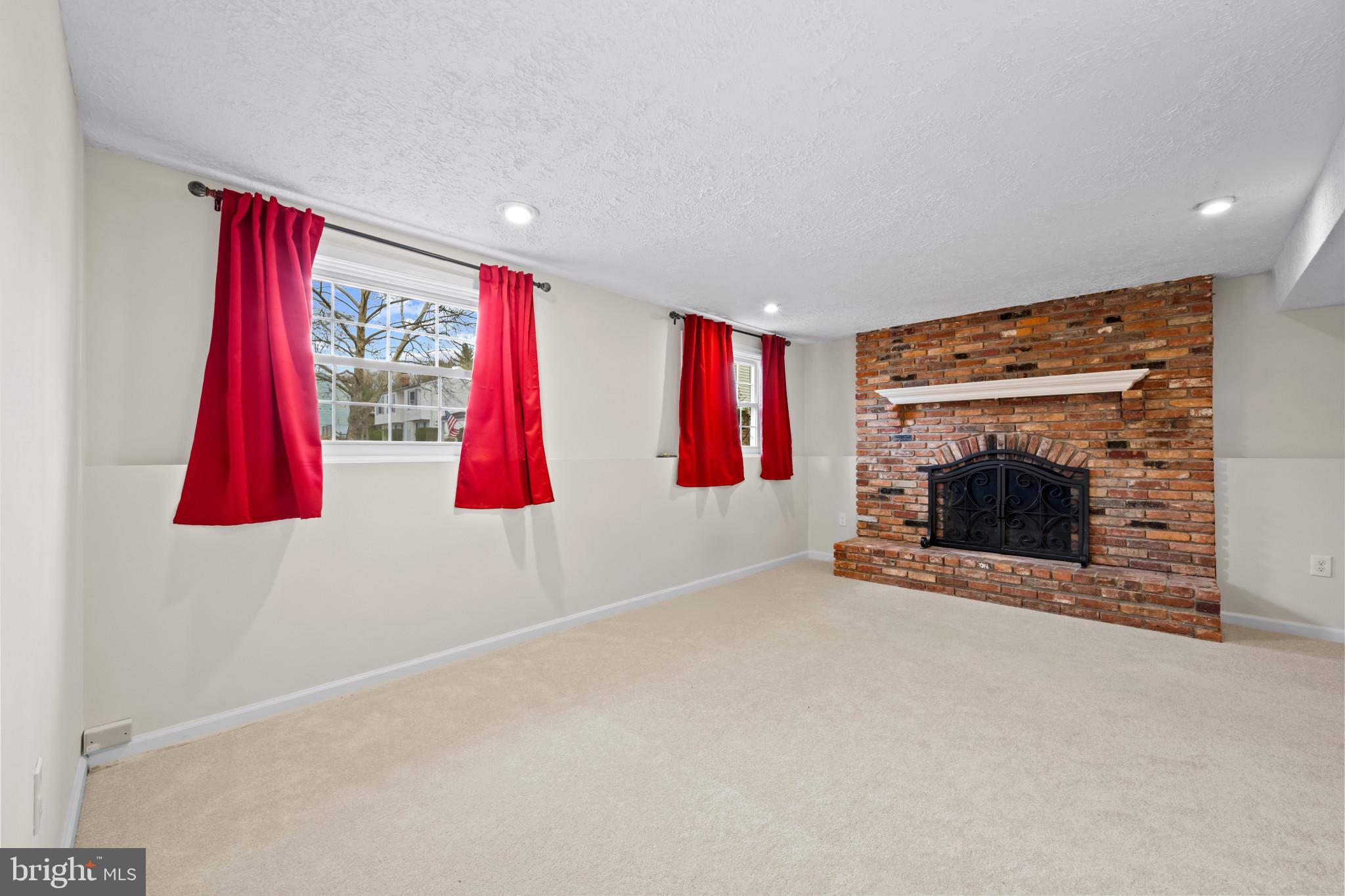9281 Pigeon Wing Place Columbia, MD 21045 - Photo 35 of 55 a living room with furniture a flat screen tv and a fireplace