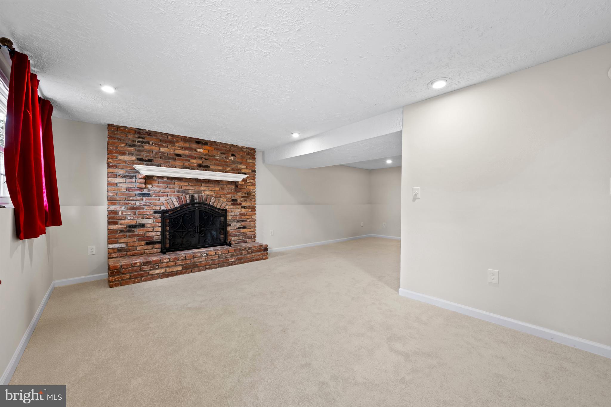 9281 Pigeon Wing Place Columbia, MD 21045 - Photo 37 of 55 a view of an empty room with a fireplace