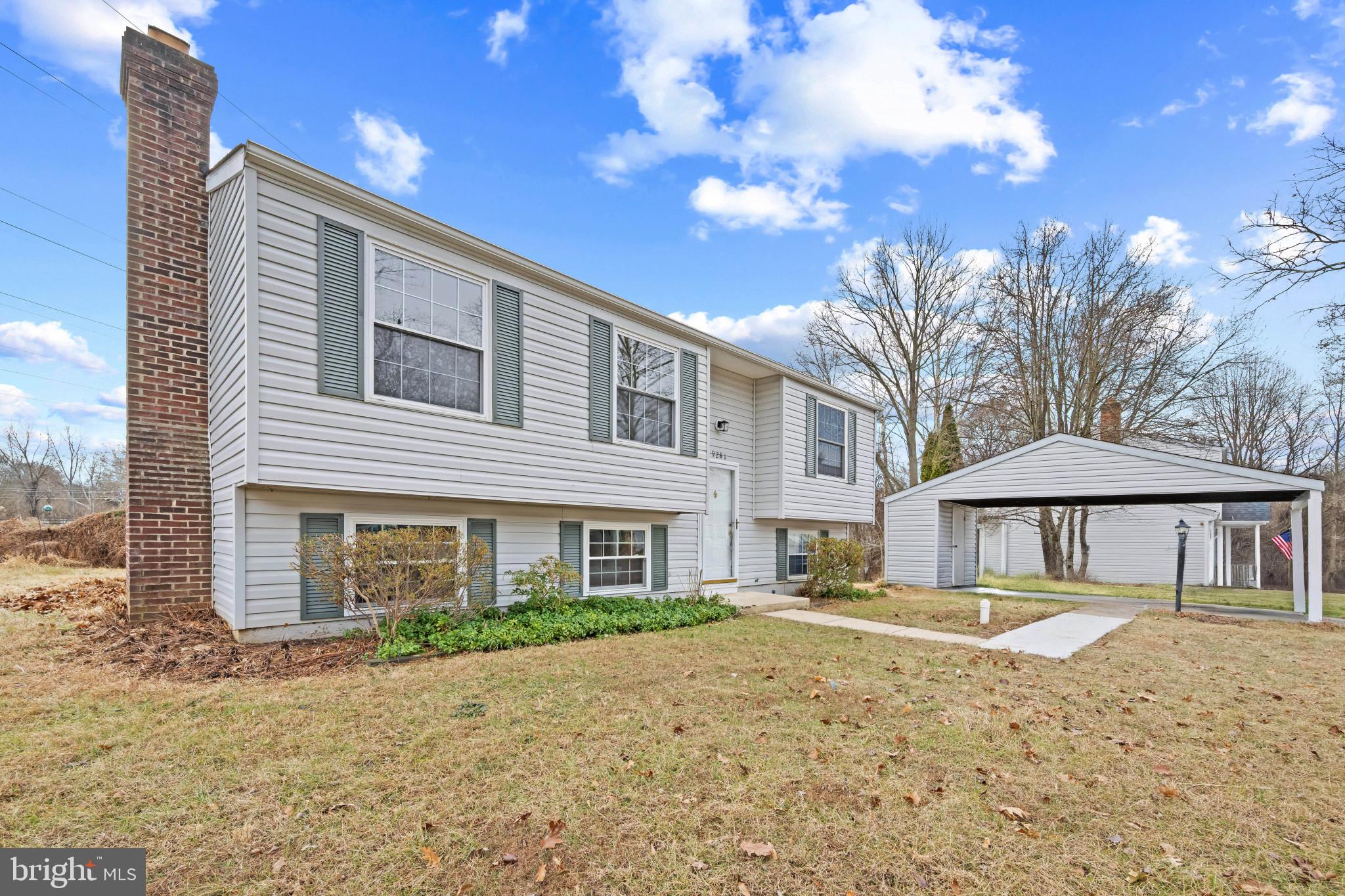 9281 Pigeon Wing Place Columbia, MD 21045 - Photo 5 of 55 a front view of a house with a yard and trees