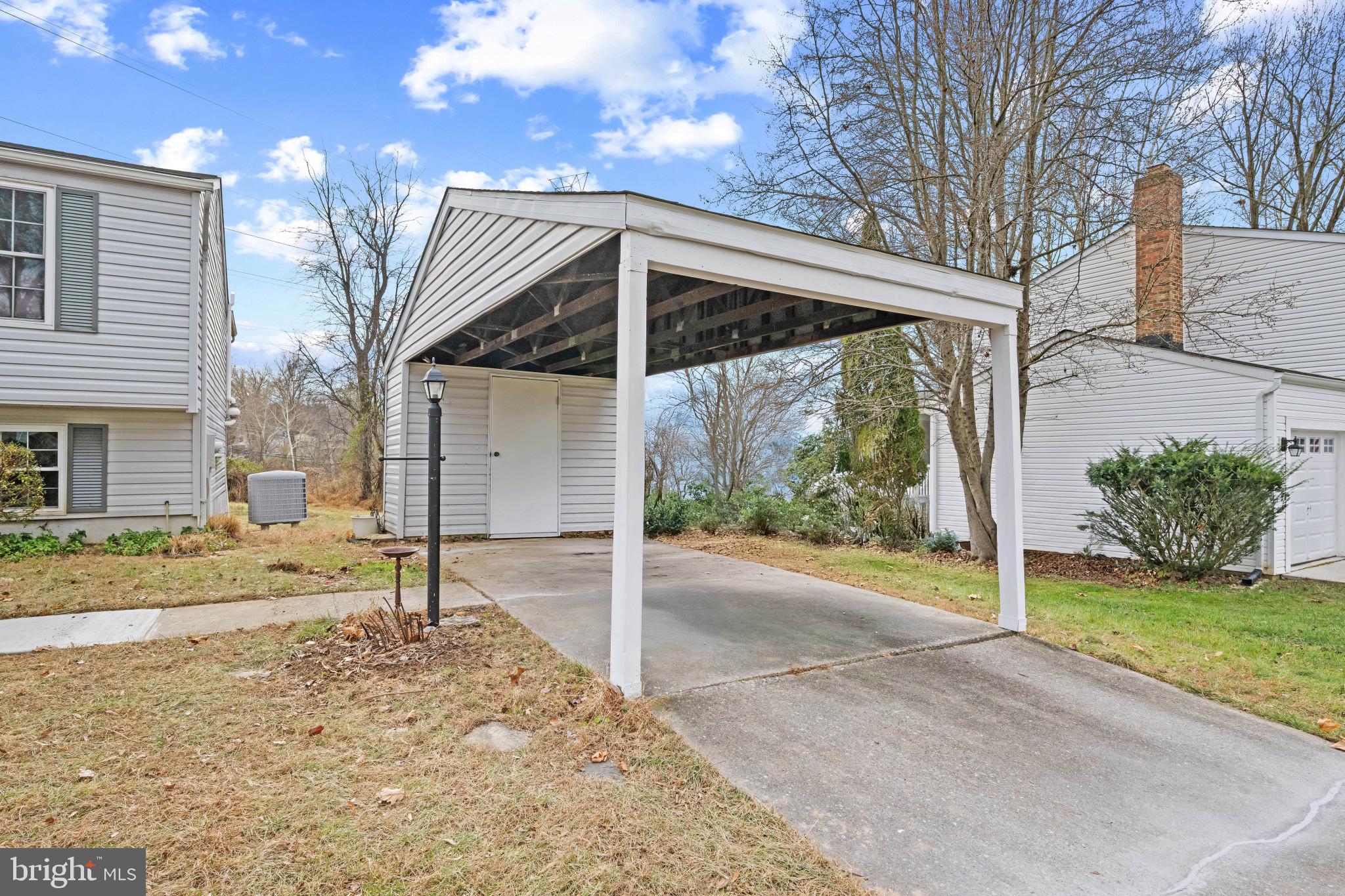 9281 Pigeon Wing Place Columbia, MD 21045 - Photo 6 of 55 a view of a house with a yard and garage
