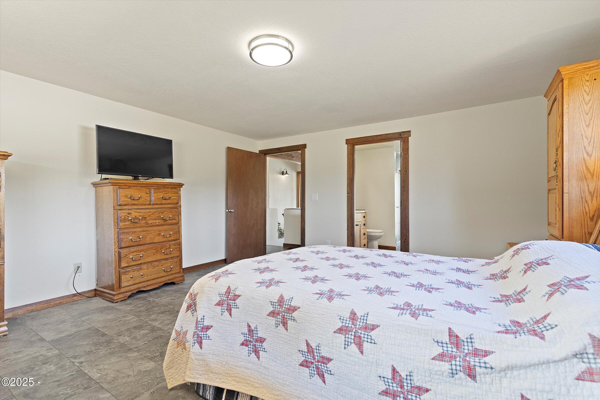 21560 Gooseneck Road Sheridan, OR 97378 - Photo 31 of 63 a bedroom with a bed and a flat screen tv