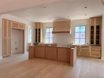 a utility room with stainless steel appliances white cabinets and a sink