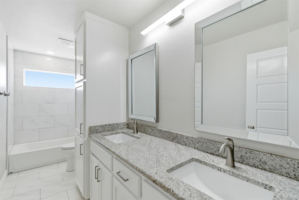 4600 Old Brock Road Weatherford, TX 76087 - Photo 19 of 37 Dual vanity with granite countertops, undermount sinks, and brushed nickel fixtures