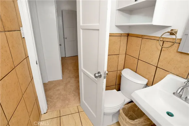 a bedroom with a bed and wooden cabinets