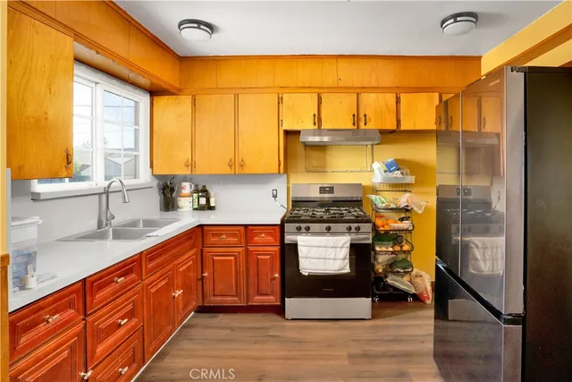 a kitchen with stainless steel appliances granite countertop a stove and a sink