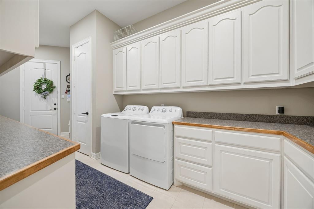 2930 Falcon Way Midlothian, TX 76065 - Photo 16 of 40 a utility room with cabinets washer and dryer