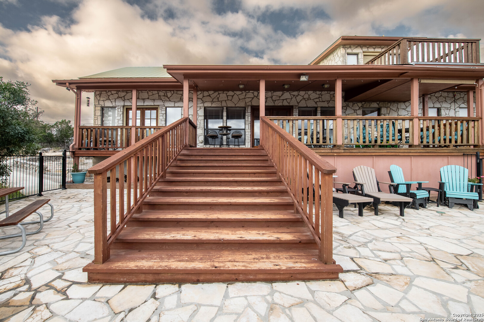 50 Indian Paint Brush Road Concan, TX 78838 - Photo 3 of 21 a view of a house with a wooden deck