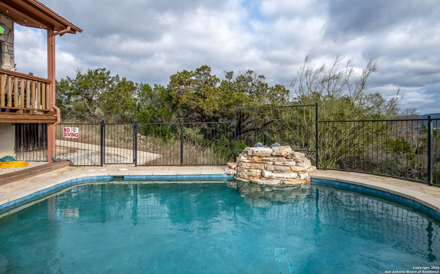 50 Indian Paint Brush Road Concan, TX 78838 - Photo 4 of 21 a swimming pool with trees in the background