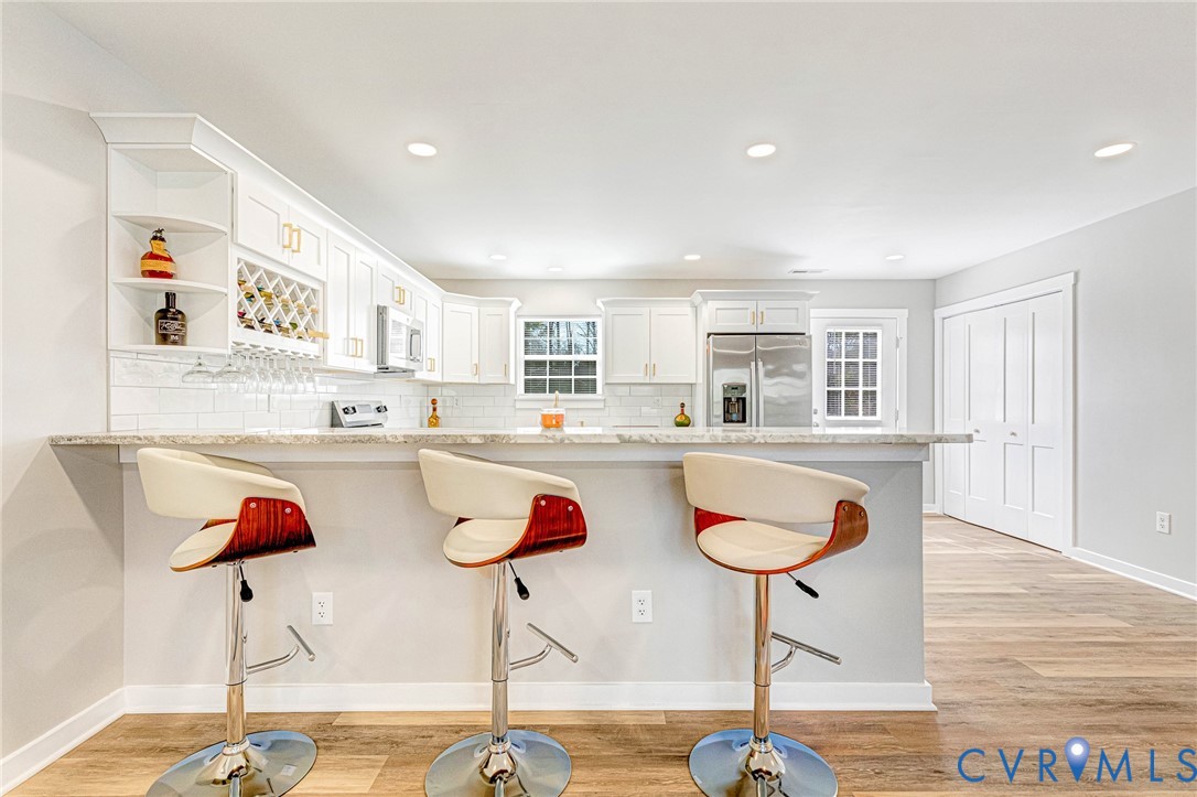5301 Pine Fork Road Quinton, VA 23141 - Photo 17 of 41 a kitchen with stainless steel appliances granite countertop a kitchen island and chairs in it