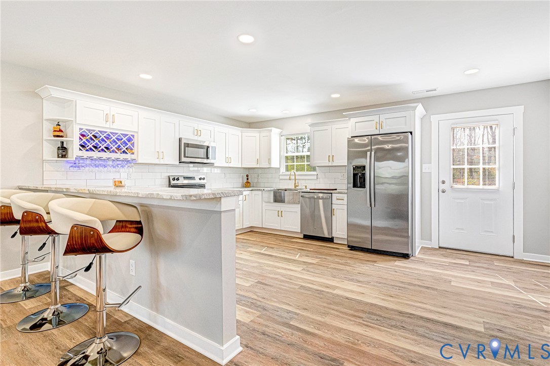 5301 Pine Fork Road Quinton, VA 23141 - Photo 18 of 41 a kitchen with stainless steel appliances granite countertop a refrigerator and a stove top oven