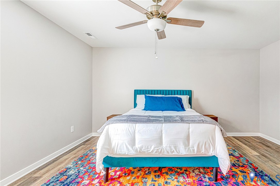 5301 Pine Fork Road Quinton, VA 23141 - Photo 32 of 41 a bed sitting in a bedroom next to a small yard