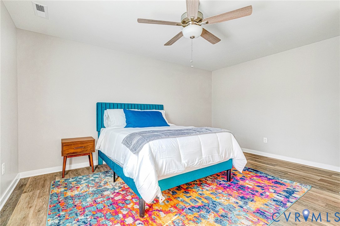 5301 Pine Fork Road Quinton, VA 23141 - Photo 34 of 41 a bedroom with a bed and a lamp on dresser