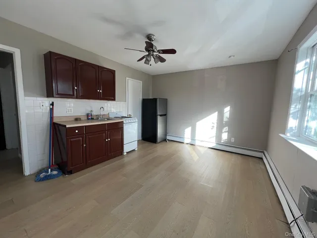 a view of a kitchen with a sink a cabinet and a fireplace