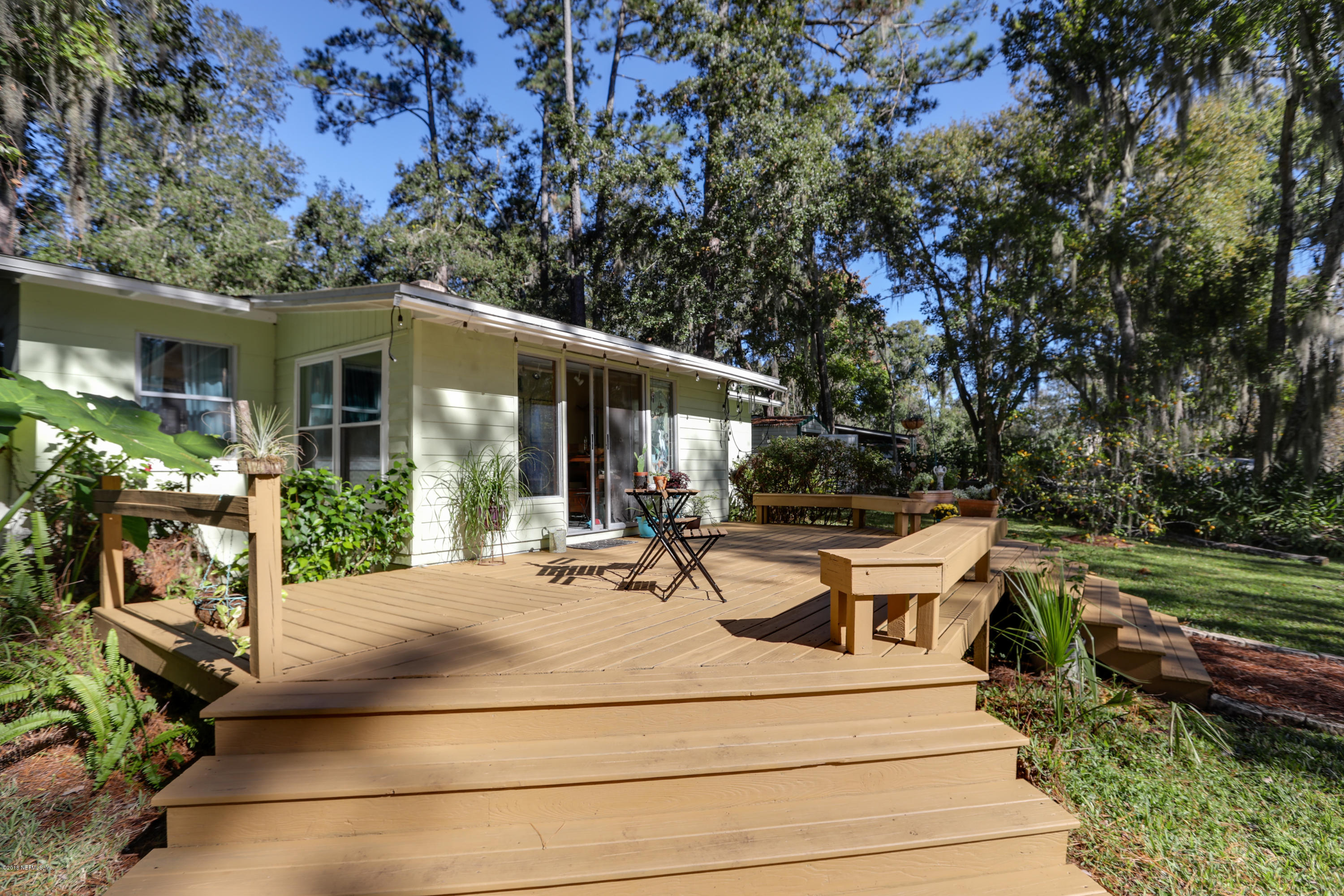 8711 Sanchez Road Jacksonville, FL 32217 - Photo 19 of 32 a view of a patio with table and chairs and potted plants