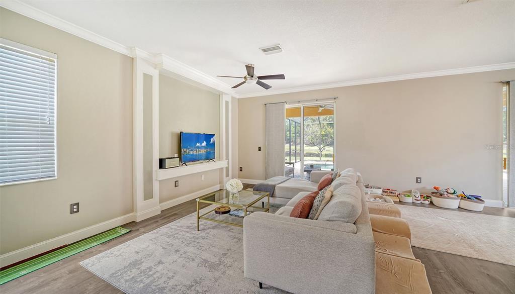 6122 Blue Runner Court Lakewood Ranch, FL 34202 - Photo 5 of 53 a living room with furniture and a flat screen tv