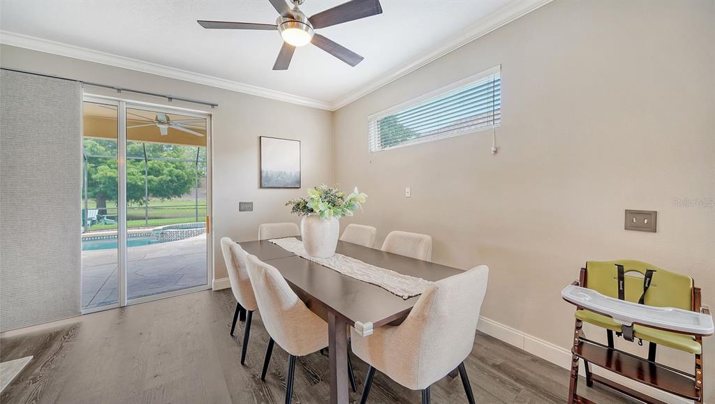 6122 Blue Runner Court Lakewood Ranch, FL 34202 - Photo 9 of 53 a dining room with furniture and window