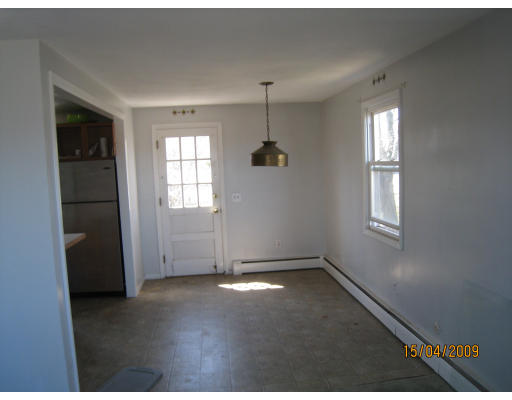 27 Broadcommon Road Bristol, RI 02809 - Photo 4 of 9 an empty room with windows