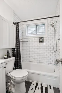 a bathroom with a toilet a sink and bathtub