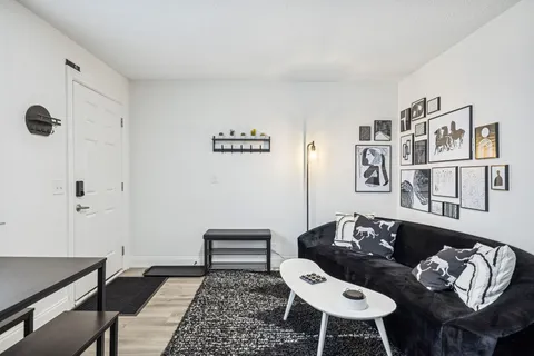 a living room with furniture and wooden floor