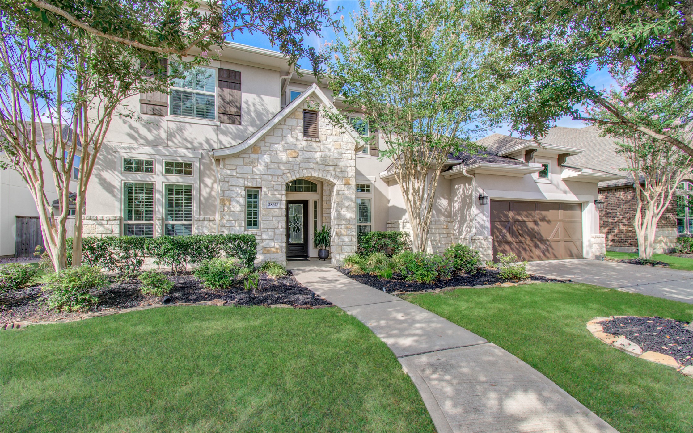 28627 Rolling Ridge Drive Katy, TX 77494 - Photo 2 of 44 a front view of a house with a garden and plants