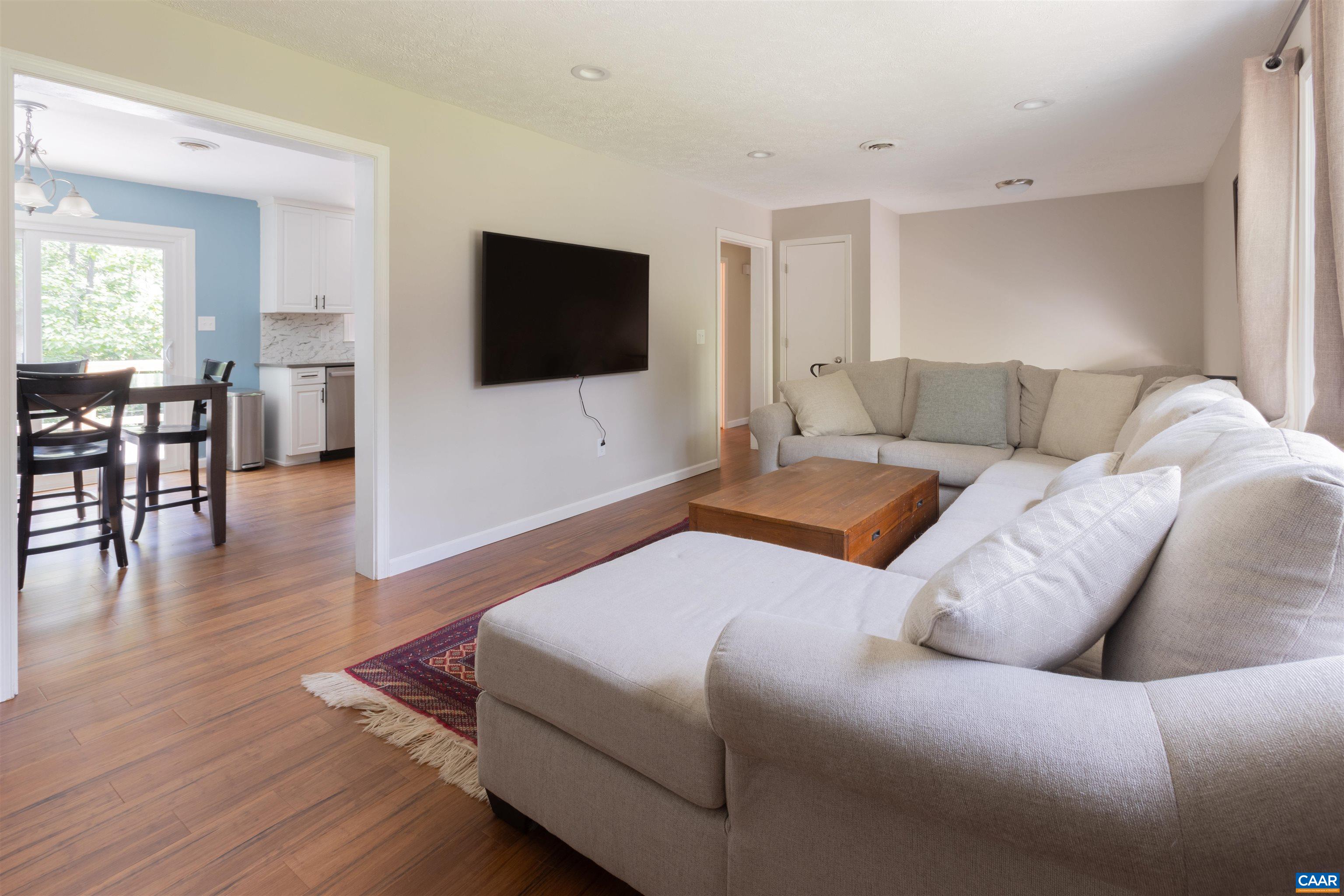 2550 Proffit Road Charlottesville, VA 22911 - Photo 10 of 41 a living room with a bed furniture and a flat screen tv