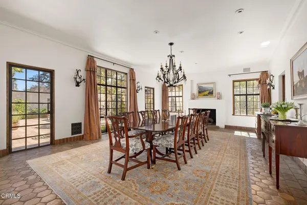 a kitchen with a stove and wooden floor