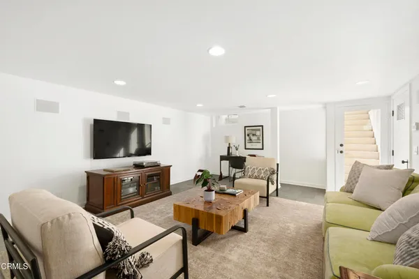 a view of a patio with couches table and chairs and potted plants