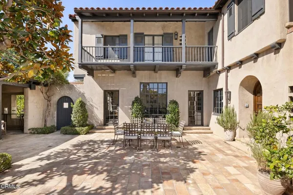 a view of a patio with table and chairs and potted plants