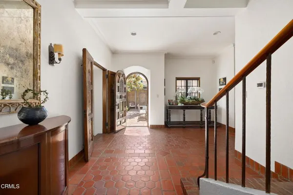 a view of an entryway with wooden floor and a livingroom view