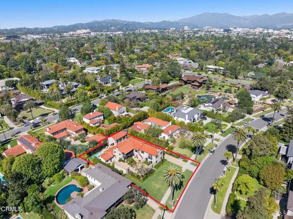 a view of a patio with couches and table and chairs with wooden fence