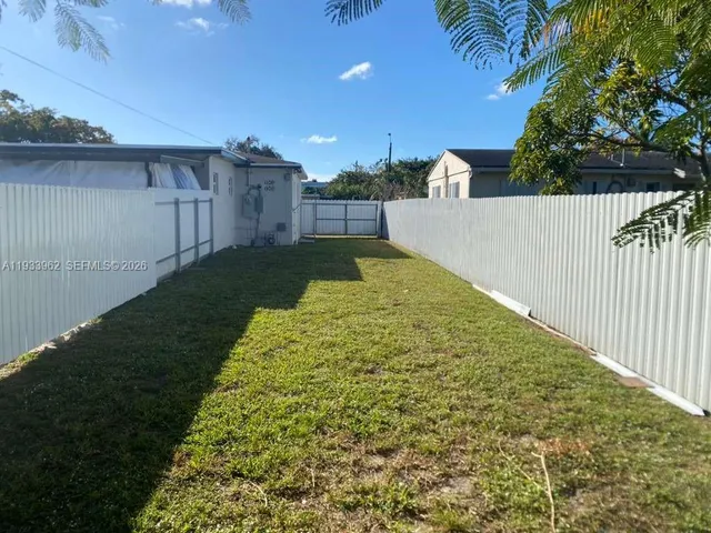 a view of backyard with green space