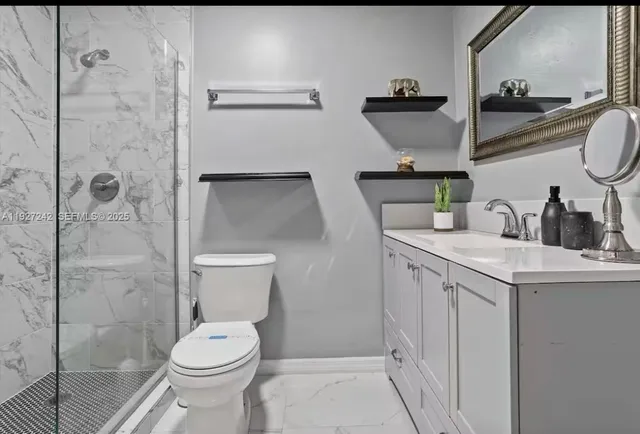 a bathroom with a sink toilet and shower