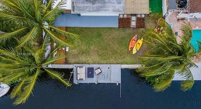 an aerial view of a house with a yard