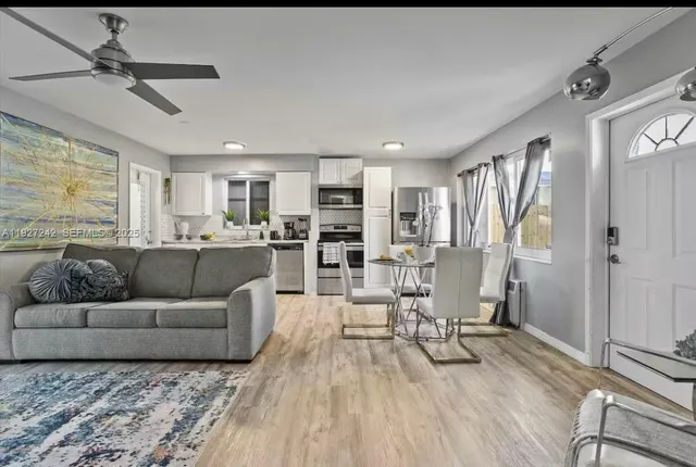 a living room with furniture and a wooden floor