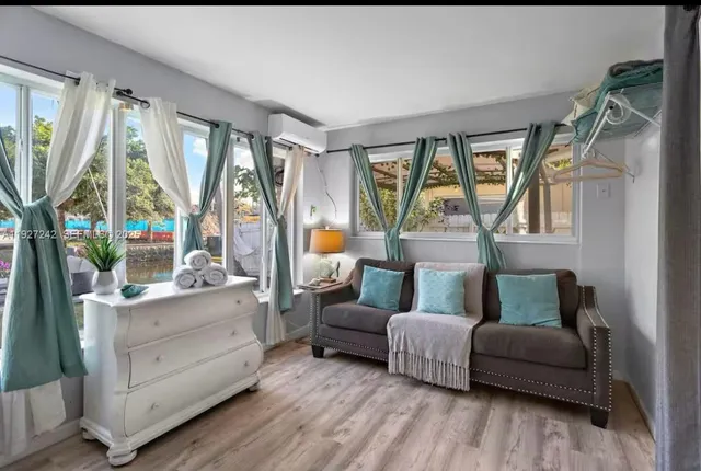 a bedroom with furniture and a large window