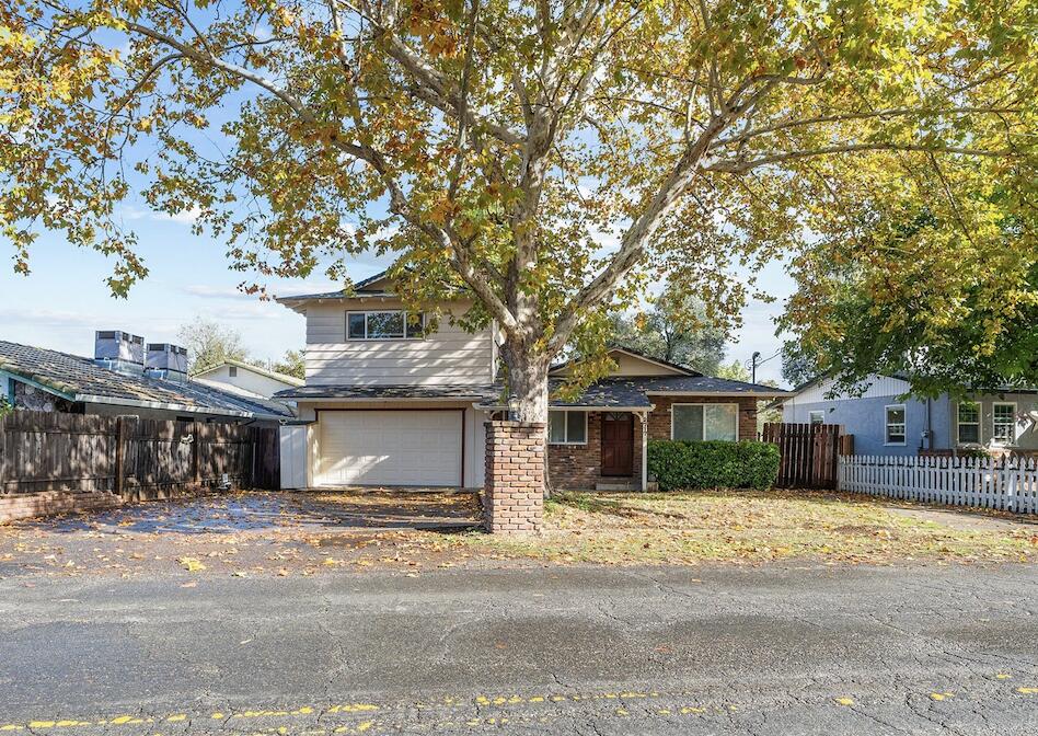 2717 Henderson Road Redding, CA 96002 - Photo 1 of 34 a front view of a house with a space and trees