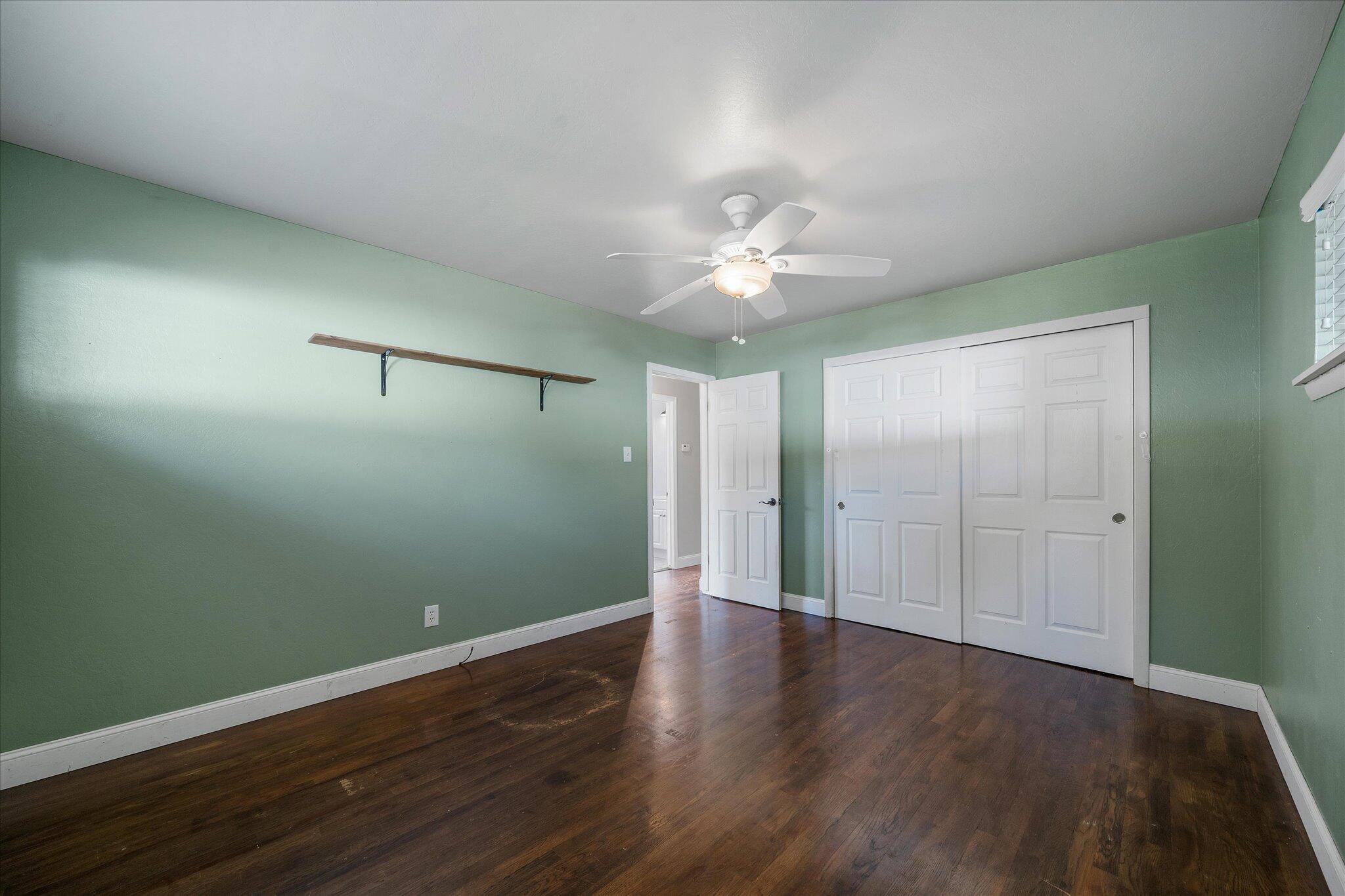 2717 Henderson Road Redding, CA 96002 - Photo 12 of 34 an empty room with wooden floor and window