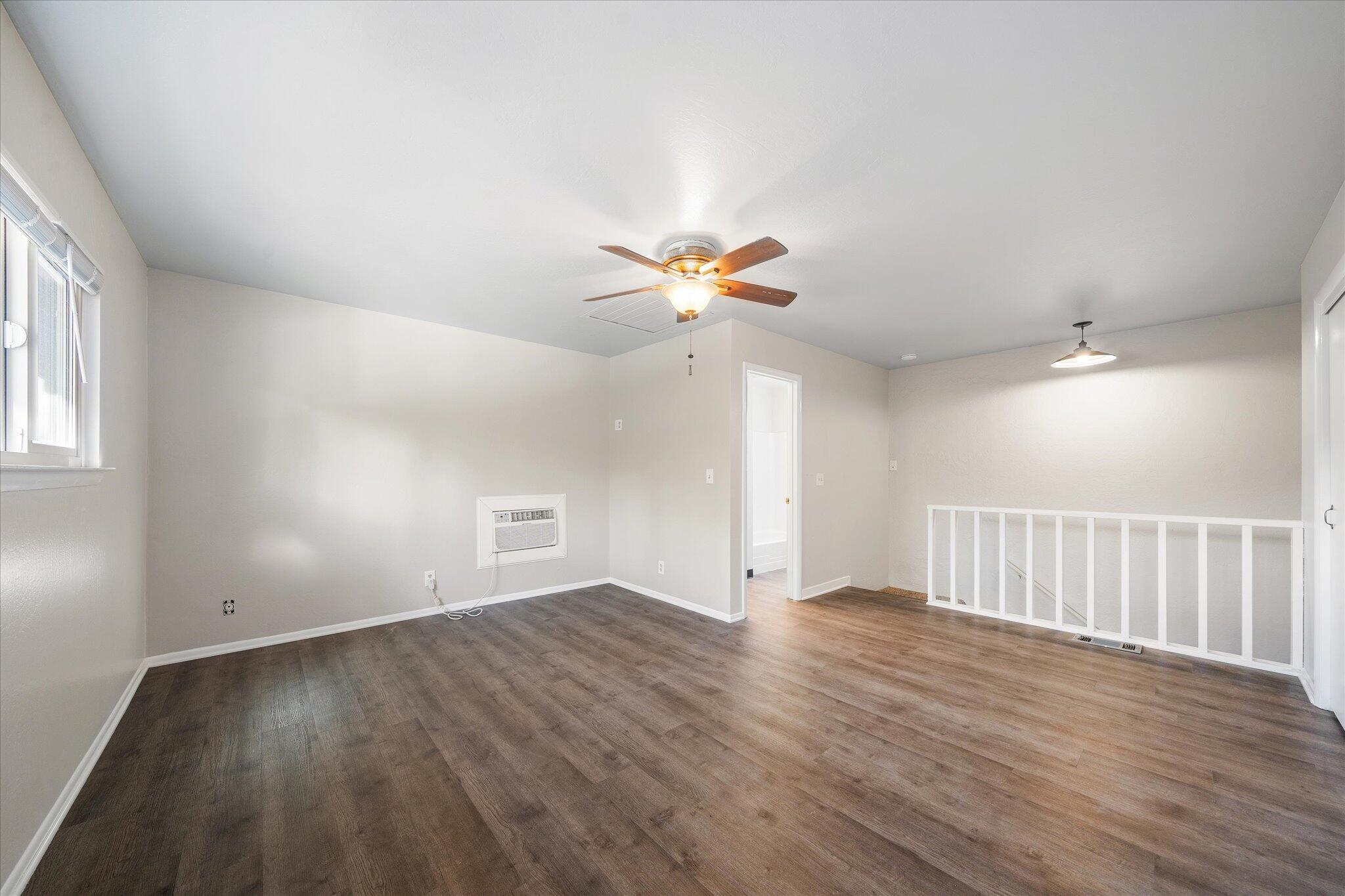 2717 Henderson Road Redding, CA 96002 - Photo 18 of 34 a view of an empty room with wooden floor and a window