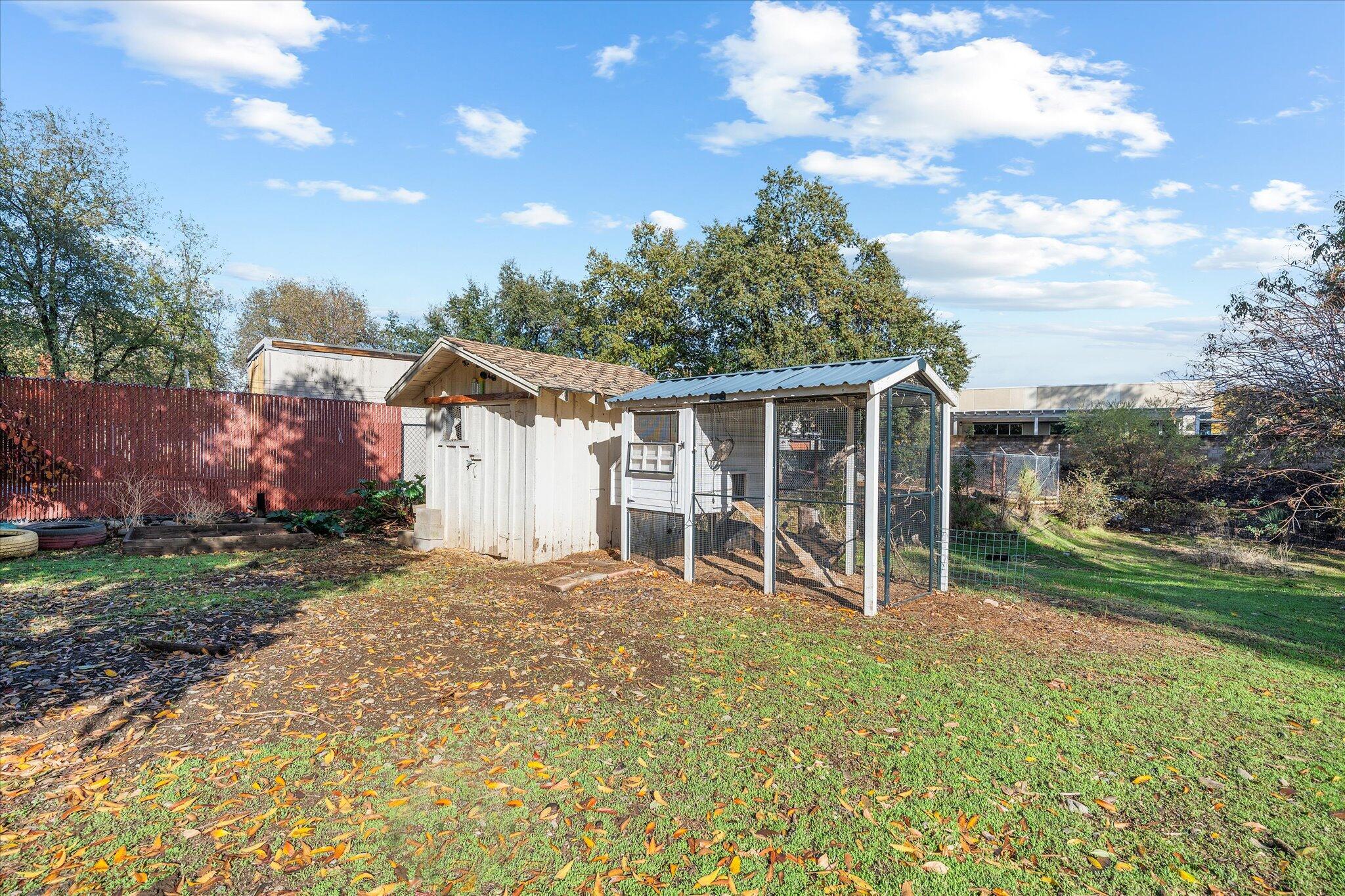 2717 Henderson Road Redding, CA 96002 - Photo 25 of 34 a view of a house with backyard and a tree