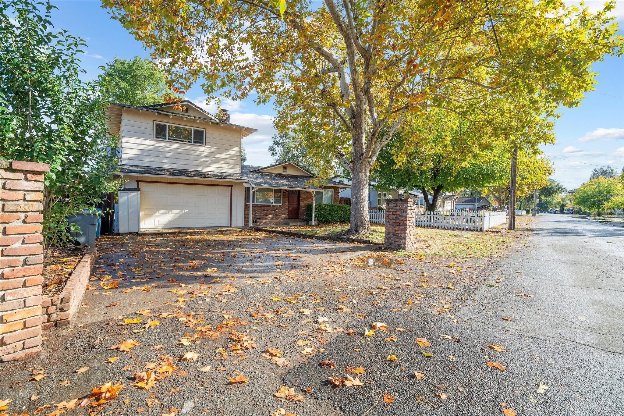 2717 Henderson Road Redding, CA 96002 - Photo 30 of 34 a front view of a house with a yard and potted plants