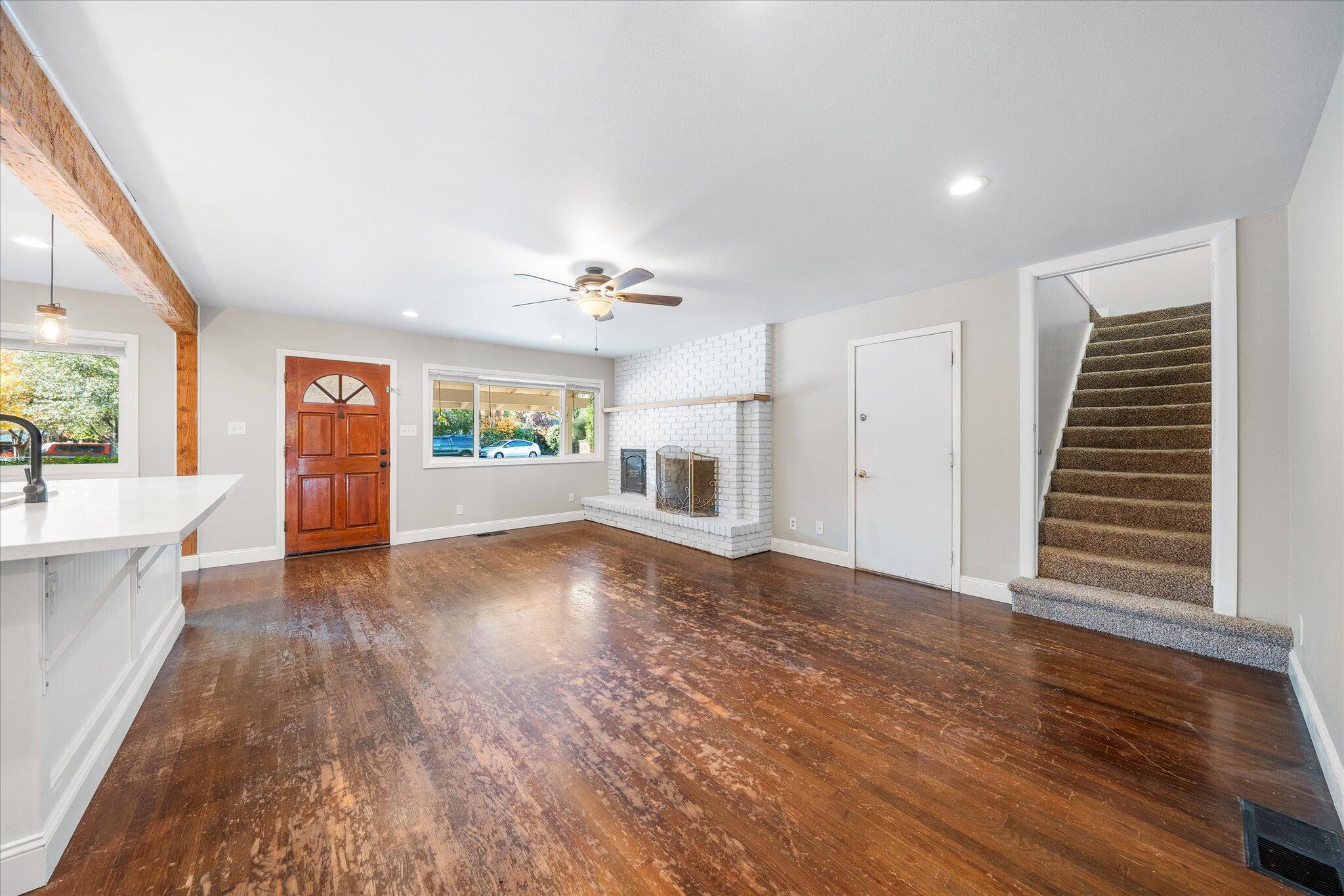 2717 Henderson Road Redding, CA 96002 - Photo 3 of 34 a view of an empty room with window and wooden floor