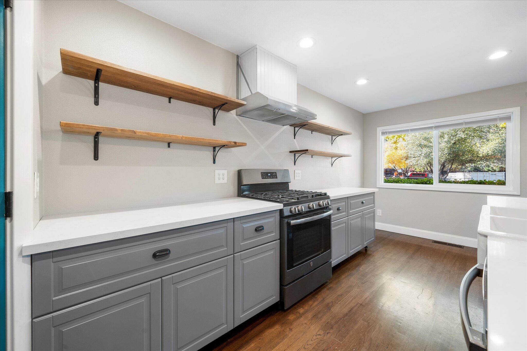 2717 Henderson Road Redding, CA 96002 - Photo 7 of 34 a kitchen with stainless steel appliances granite countertop a stove and a refrigerator