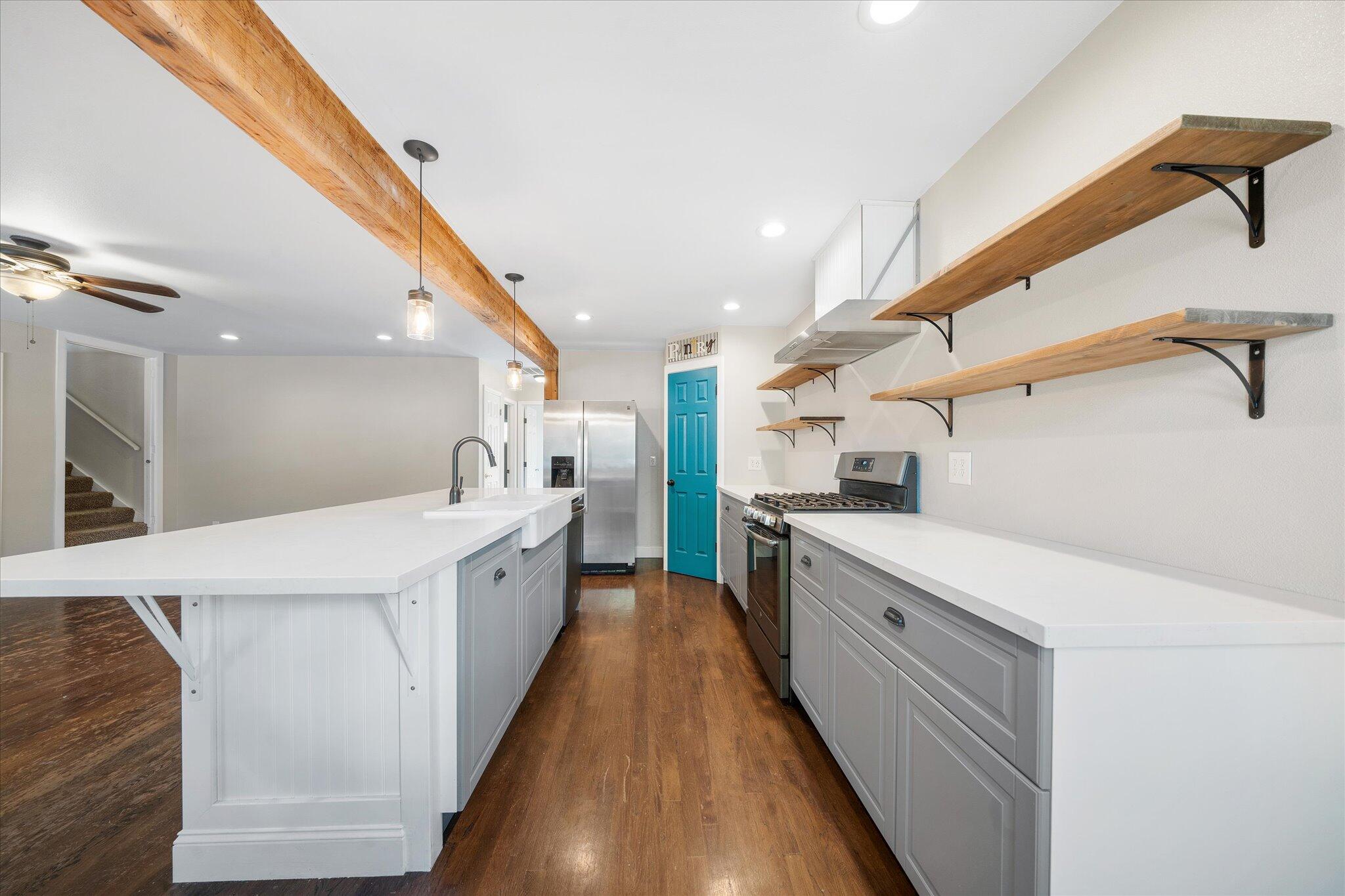 2717 Henderson Road Redding, CA 96002 - Photo 8 of 34 a large kitchen with a large counter top a sink a window and stainless steel appliances