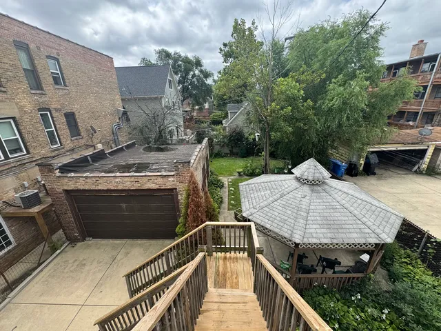 a view of a balcony and yard