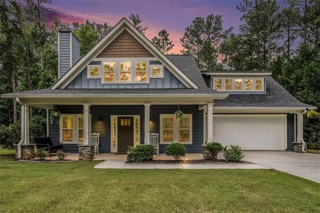 a view of a house with sitting area and garden